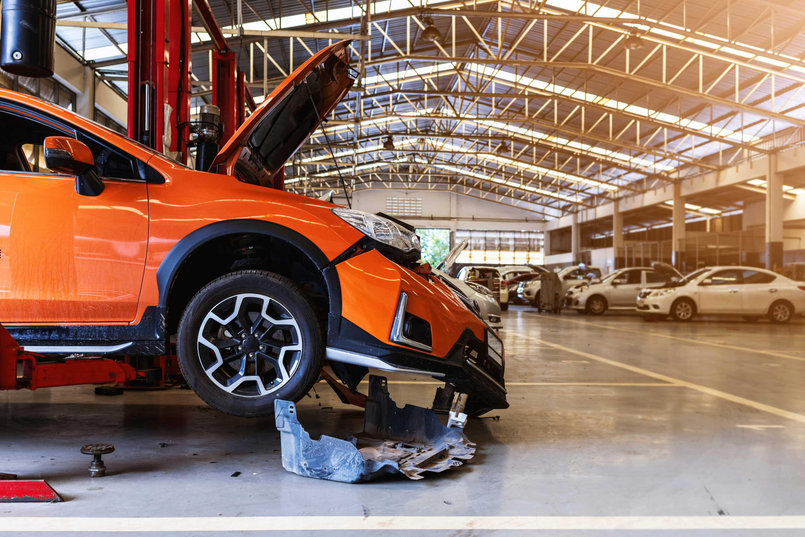 Tsco Orange Car Orange vehicle inside an independent collision repair shop